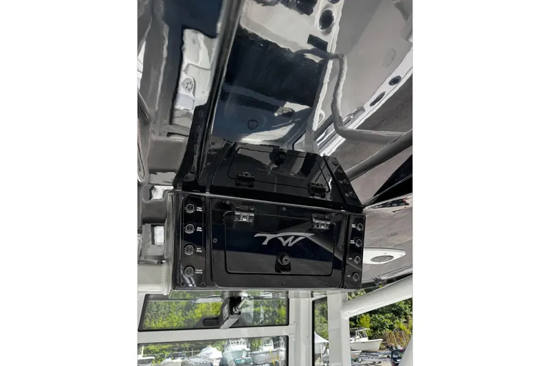 Slide: The Image of 2026 Tidewater 232 CC Adventure boat cockpit with steering wheel and controls. - 16