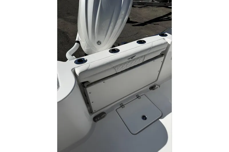 Slide: The Image of 2026 Tidewater 232 CC Adventure boat console with control panel and storage compartment. - 17