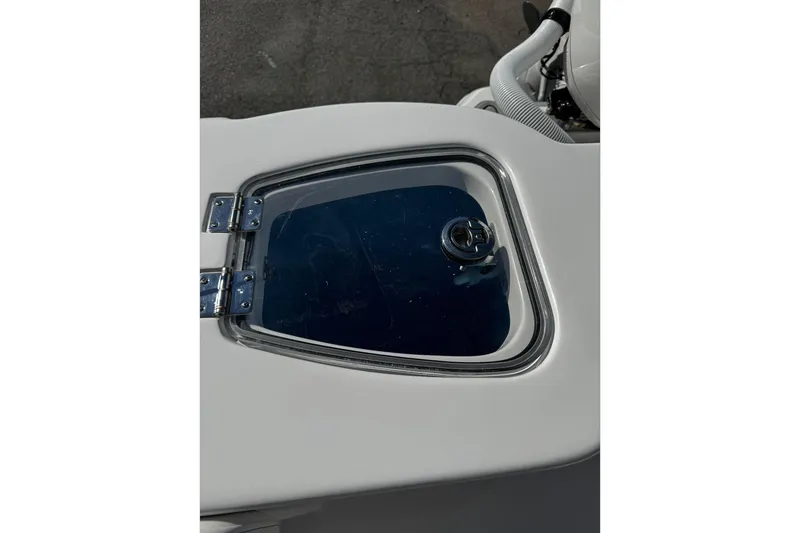 Slide: The Image of 2026 Tidewater 232 CC Adventure boat interior with seating and storage compartments. - 18