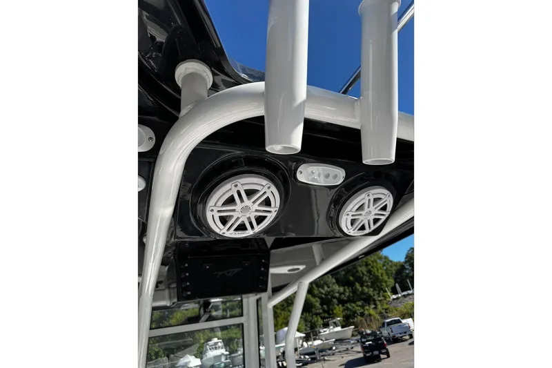 Slide: The Image of 2026 Tidewater 232 CC Adventure boat speakers and rod holders under canopy. - 27