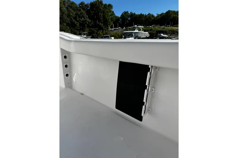 Slide: The Image of 2026 Tidewater 232 CC Adventure boat interior detail with storage compartment. - 28