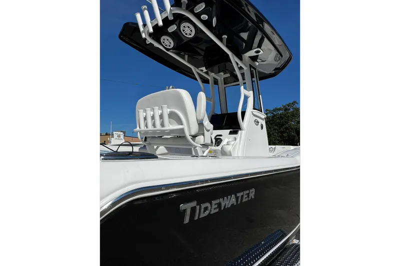 Slide: The Image of 2026 Tidewater 232 CC Adventure boat on trailer under clear blue sky. - 3