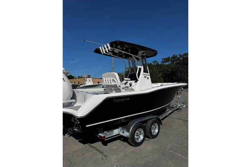 Slide: The Image of 2026 Tidewater 232 CC Adventure boat, sleek design, white seating, and black hull. - 4