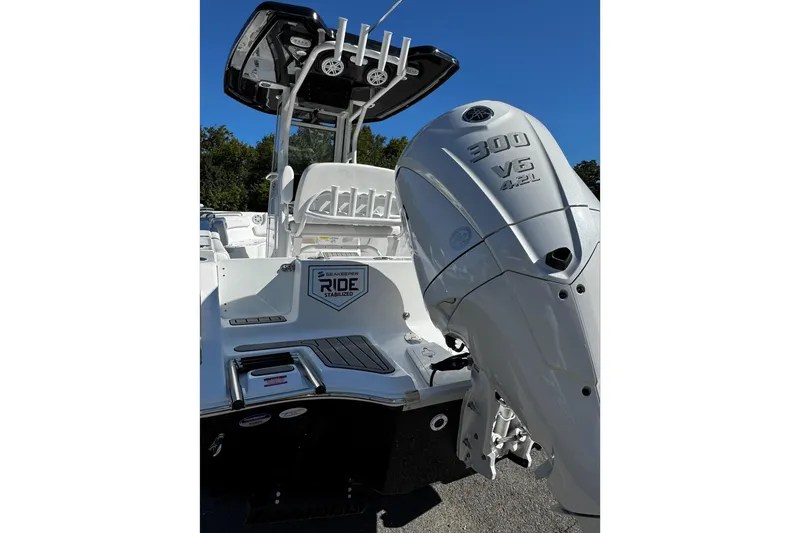 Slide: The Image of 2026 Tidewater 232 CC Adventure boat on trailer under bright sun. - 7