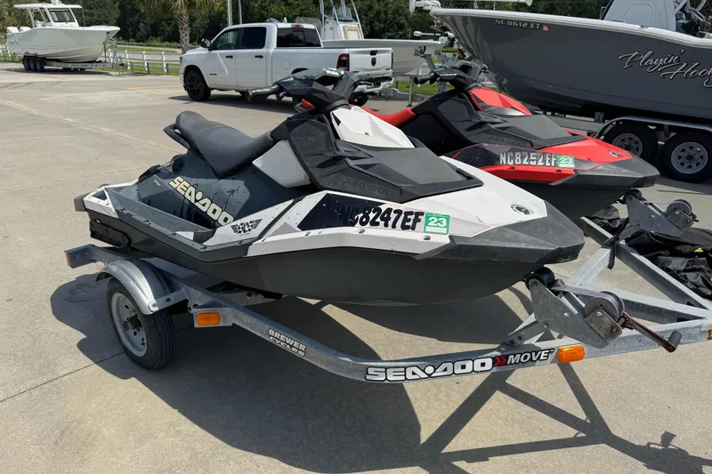 Slide: The Image of 2017 Sea-Doo Spark 2up jet ski on trailer, parked outdoors. - 5