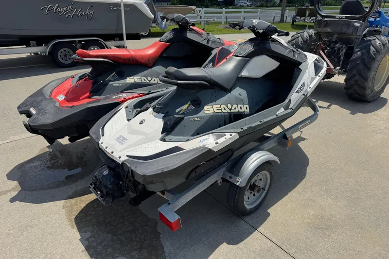 Slide: The Image of 2017 Sea-Doo Spark 2up jet skis on a trailer, parked outdoors. - 6
