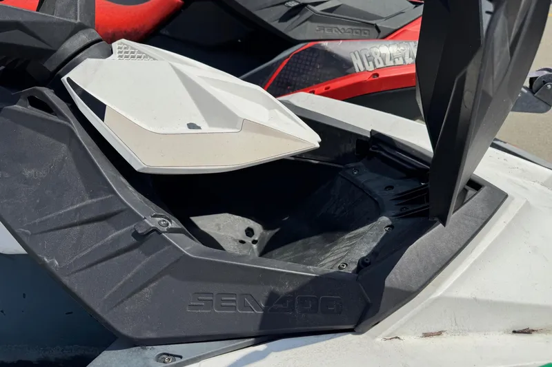 Slide: The Image of 2017 Sea-Doo Spark 2up storage compartment open, showcasing interior space. - 7