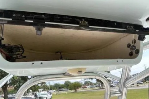 Slide: The Image of 2018 Key West 239 FS boat storage compartment with open lid, showing interior and wiring. - 10