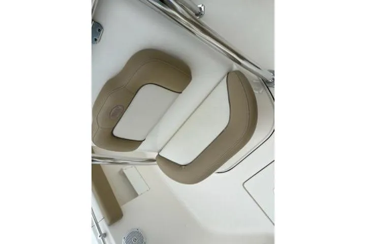 Slide: The Image of 2018 Key West 239 FS boat interior seating with beige and white cushions. - 11