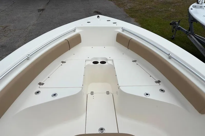 Slide: The Image of 2018 Key West 239 FS boat interior with beige seating and storage compartments. - 15