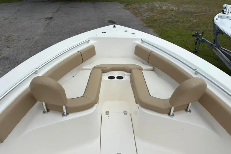 Slide: The Image of 2018 Key West 239 FS boat interior with beige seating and cup holders. - 17