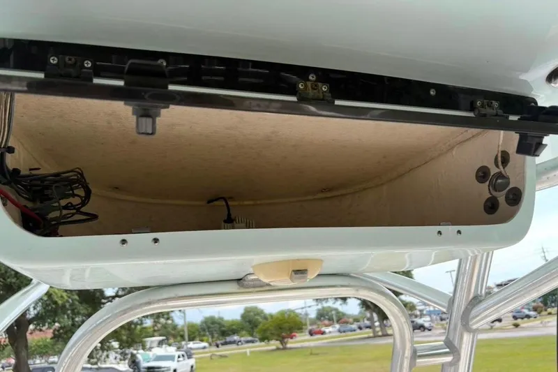 Slide: The Image of 2018 Key West 239 FS boat storage compartment with open lid, showing interior wiring. - 19