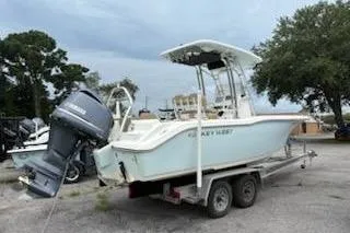 Slide: The Image of 2018 Key West 239 FS boat on trailer with outboard motor, parked outdoors. - 3