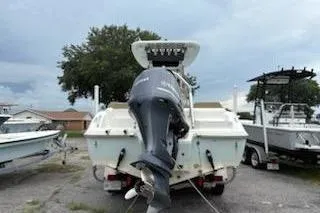Slide: The Image of 2018 Key West 239 FS boat with outboard motor, parked on a trailer in a lot. - 4