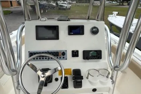 Slide: The Image of 2018 Key West 239 FS boat dashboard with steering wheel and navigation instruments. - 8
