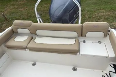 Slide: The Image of 2018 Key West 239 FS boat interior with beige and white seating. - 9