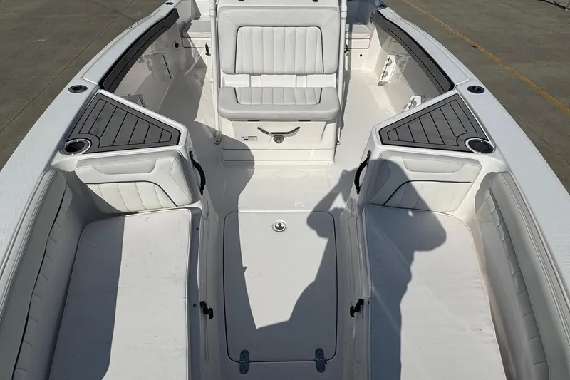Slide: The Image of 2018 Yamaha Boats 210 FSH interior, featuring spacious seating and storage compartments. - 10