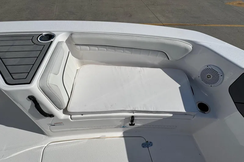Slide: The Image of 2018 Yamaha Boats 210 FSH interior seating with cup holder and speaker. - 12
