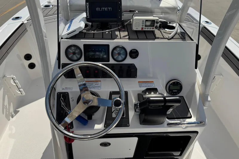 Slide: The Image of 2018 Yamaha Boats 210 FSH dashboard with steering wheel and navigation controls. - 18