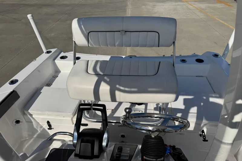 Slide: The Image of 2018 Yamaha Boats 210 FSH interior with steering wheel and seating. - 19