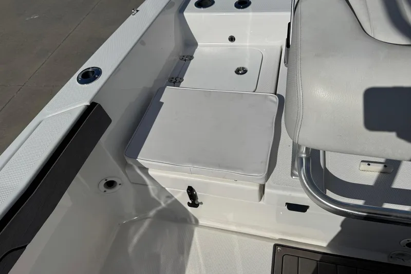 Slide: The Image of 2018 Yamaha Boats 210 FSH interior detail, featuring seating and storage compartments. - 21