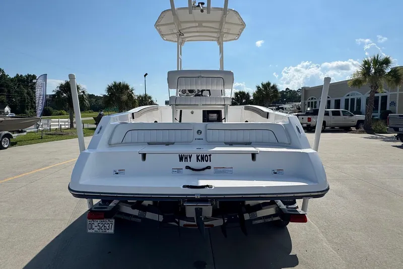 Slide: The Image of 2018 Yamaha Boats 210 FSH, rear view, parked outdoors on a sunny day. - 3