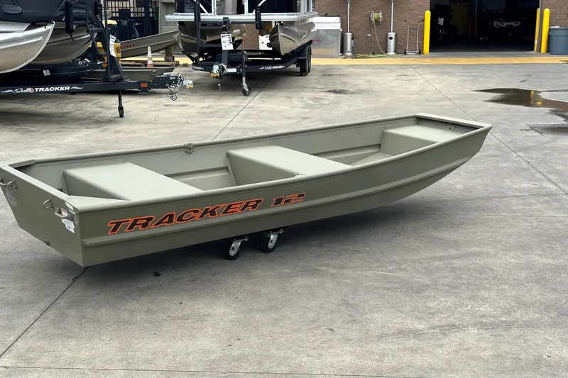 Slide: The Image of 2026 Tracker Grizzly 12 Jon boat on concrete surface, showcasing sturdy design. - 2