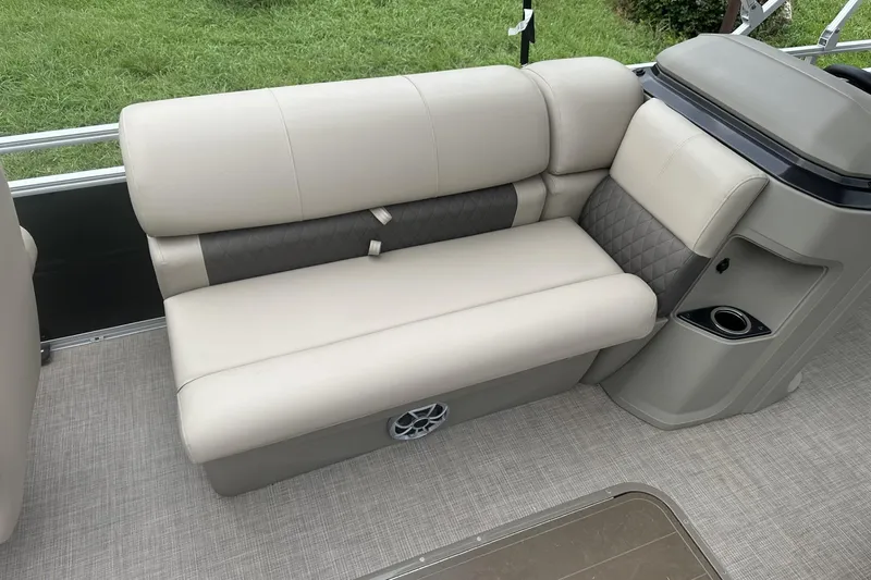 Slide: The Image of 2025 Sun Tracker Sportfish 24 XP3 boat interior with beige seating and cup holder. - 15