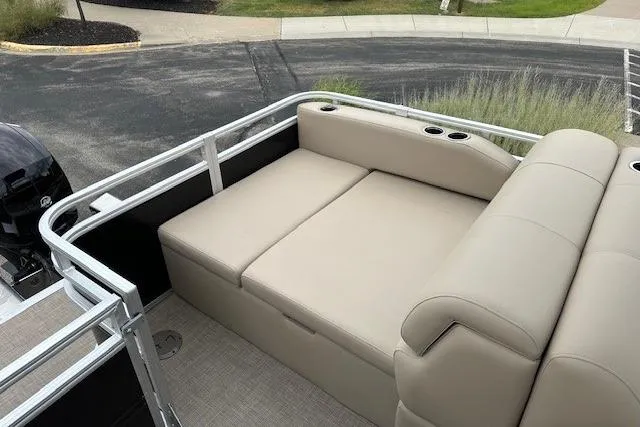 Slide: The Image of 2025 Sun Tracker Sportfish 24 XP3 pontoon boat with beige seating and cup holders. - 6