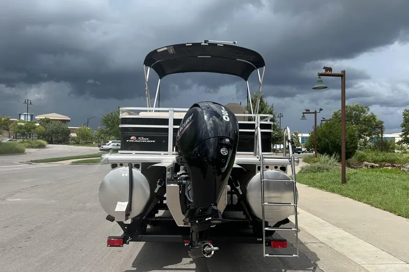 Slide: The Image of 2025 Sun Tracker Sportfish 24 XP3 boat with Mercury outboard motor under stormy skies. - 2
