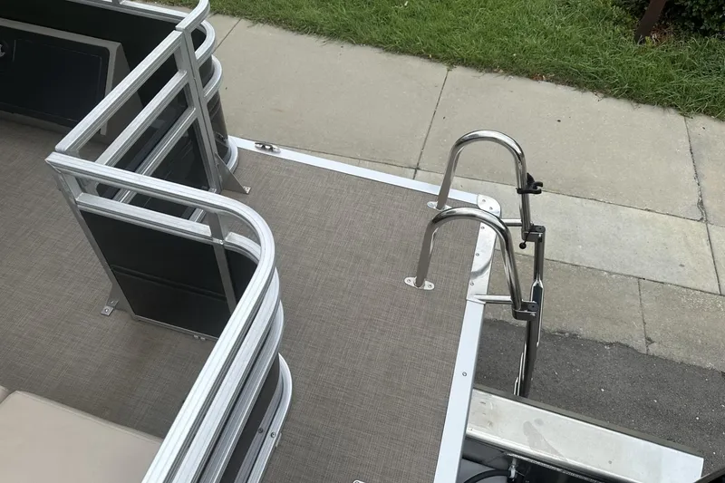 Slide: The Image of 2025 Sun Tracker Sportfish 24 XP3 boat deck with railing and ladder, viewed from above. - 31