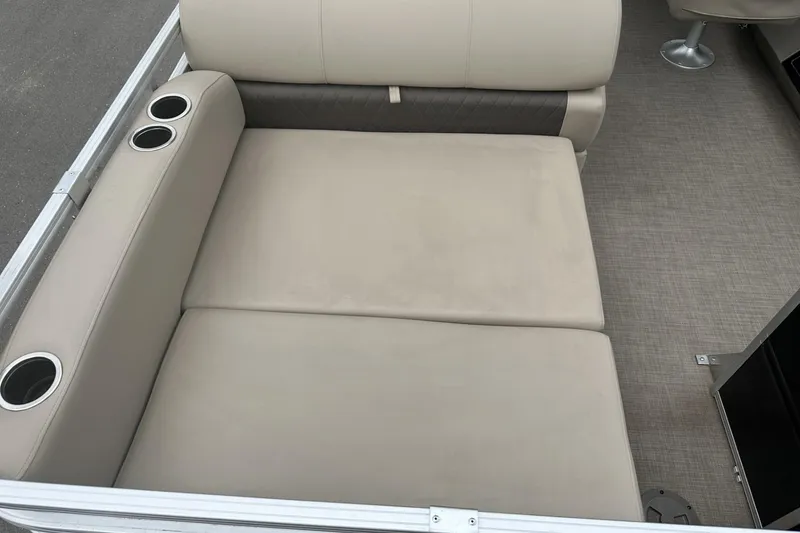 Slide: The Image of 2025 Sun Tracker Sportfish 24 XP3 boat seating with cup holders, beige upholstery. - 28