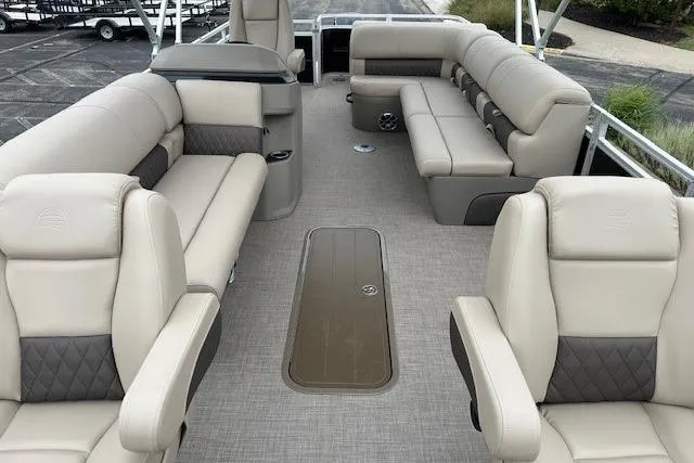 Slide: The Image of 2025 Sun Tracker Sportfish 24 XP3 pontoon boat interior with beige seating and spacious layout. - 9