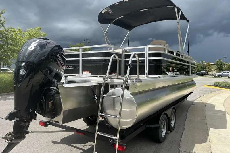 Slide: The Image of 2025 Sun Tracker Sportfish 24 XP3 pontoon boat with Mercury 150 engine on trailer. - 3