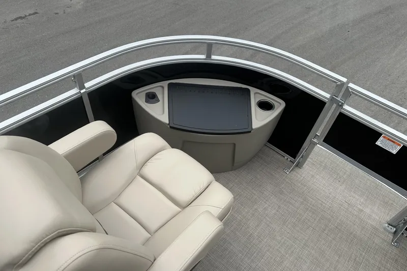 Slide: The Image of 2025 Sun Tracker Sportfish 24 XP3 boat interior with beige seating and control panel. - 12