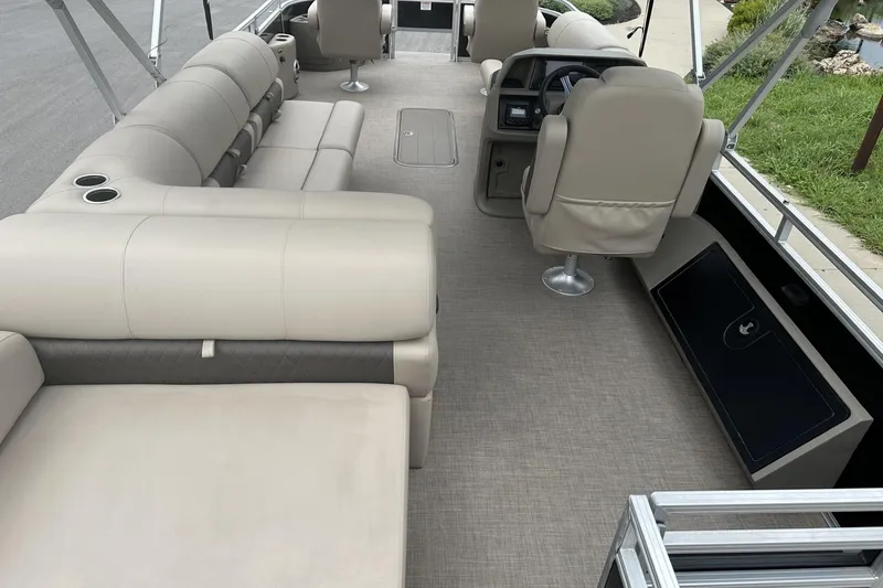 Slide: The Image of 2025 Sun Tracker Sportfish 24 XP3 interior with beige seating and modern helm. - 26