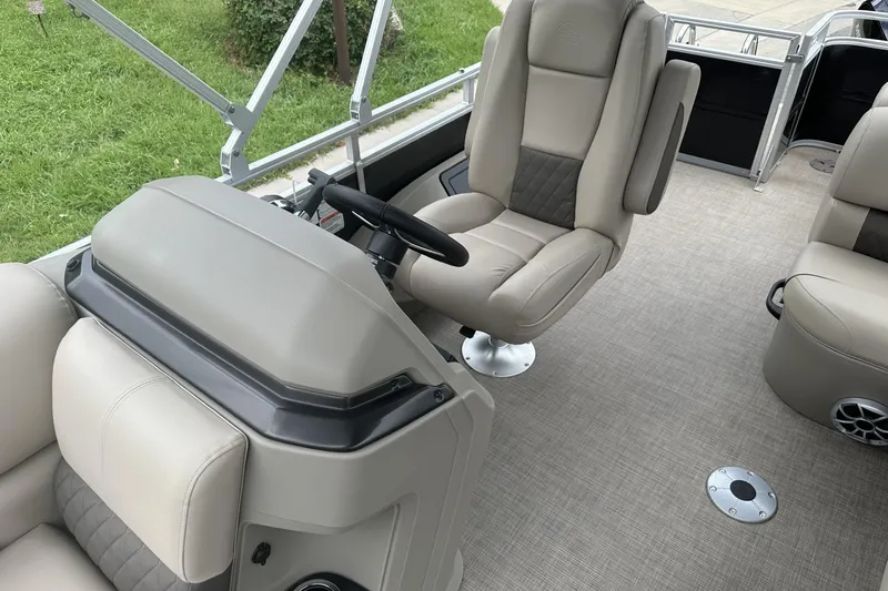 Slide: The Image of 2025 Sun Tracker Sportfish 24 XP3 interior with plush seating and modern helm design. - 17