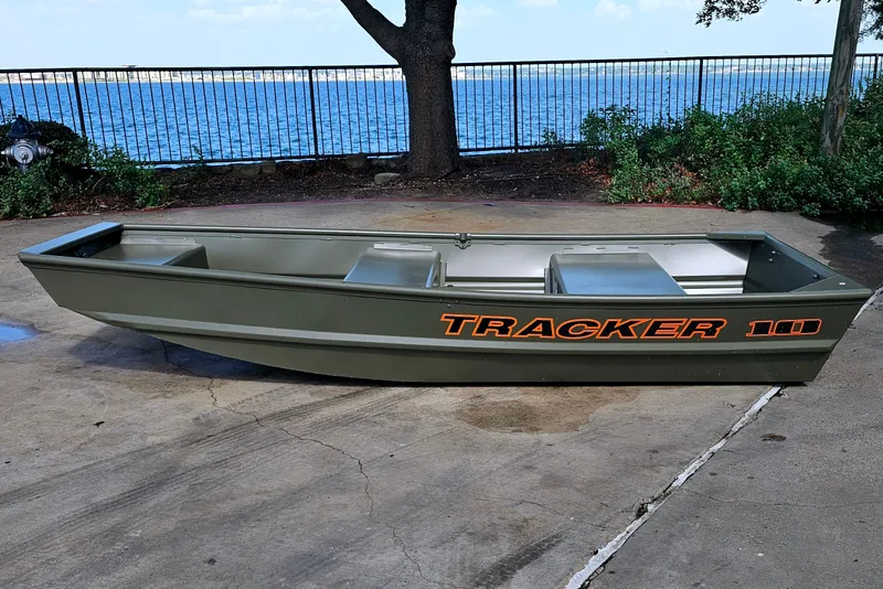 The Image of 2026 Tracker Grizzly 10 Jon boat on concrete near waterfront. - 0