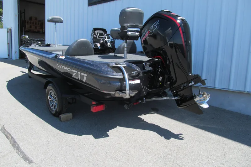 Slide: The Image of 2026 Nitro Z17 boat with powerful outboard motor, parked outside a building. - 2