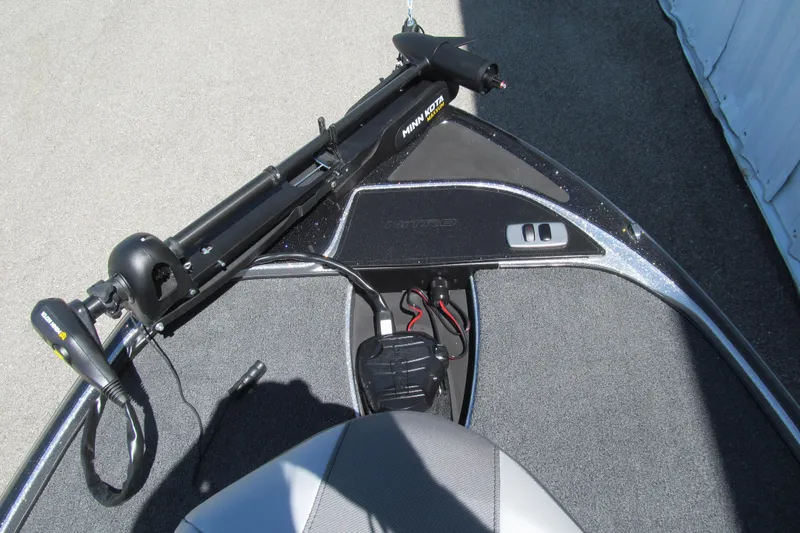 Slide: The Image of 2026 Nitro Z17 boat deck with Minn Kota trolling motor, gray carpet, and control panel. - 8