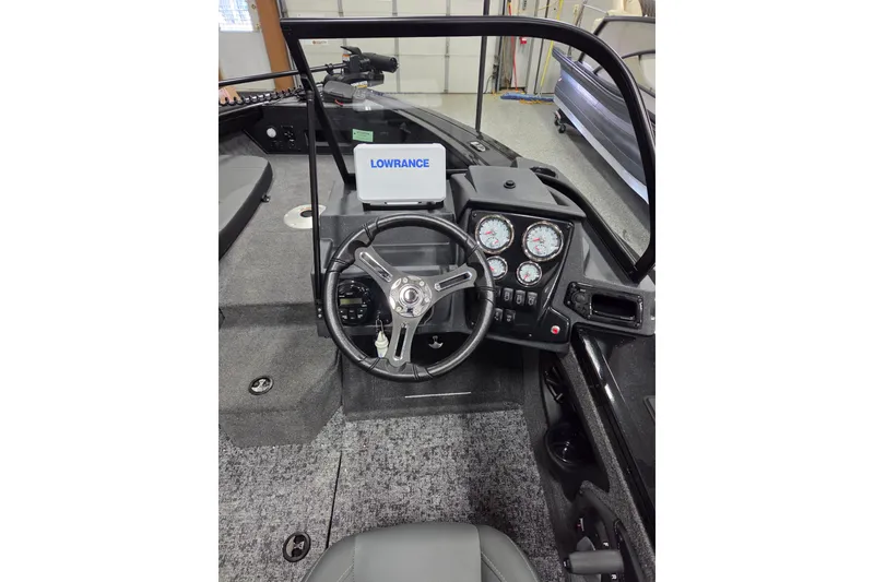 Slide: The Image of 2026 Tracker Targa V-18 Combo boat interior with four gray seats and steering wheel. - 6
