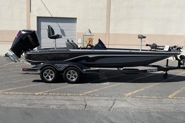The Image of 2026 Nitro Z21 XL Pro boat on trailer, parked outdoors, side view. - 1