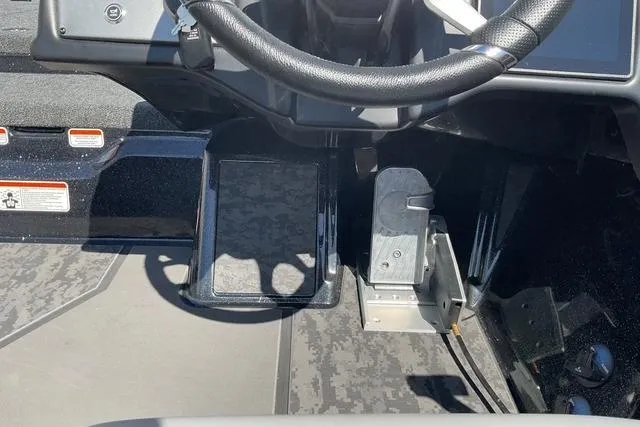 Slide: The Image of 2026 Nitro Z21 XL Pro boat cockpit with steering wheel and pedal controls. - 12