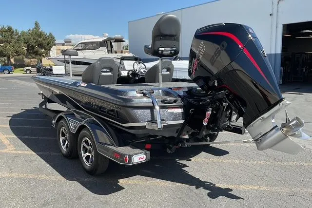 Slide: The Image of 2026 Nitro Z21 XL Pro boat with powerful outboard motor in a parking lot. - 4