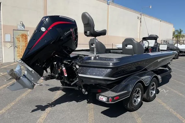 Slide: The Image of 2026 Nitro Z21 XL Pro boat with powerful outboard motor in a parking lot. - 6