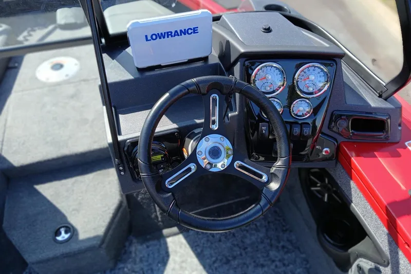 Slide: The Image of 2026 Tracker Targa V-18 Combo boat dashboard with steering wheel and gauges. - 2