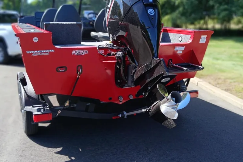 Slide: The Image of 2026 Tracker Targa V-18 Combo boat, red exterior, parked on a trailer. - 6