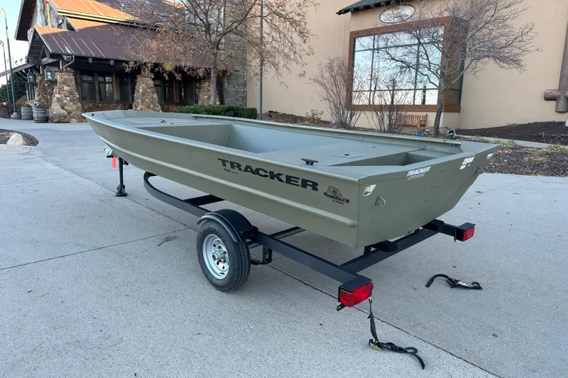 Slide: The Image of 2026 Tracker Grizzly 1648 Utility boat on trailer, parked outdoors. - 2