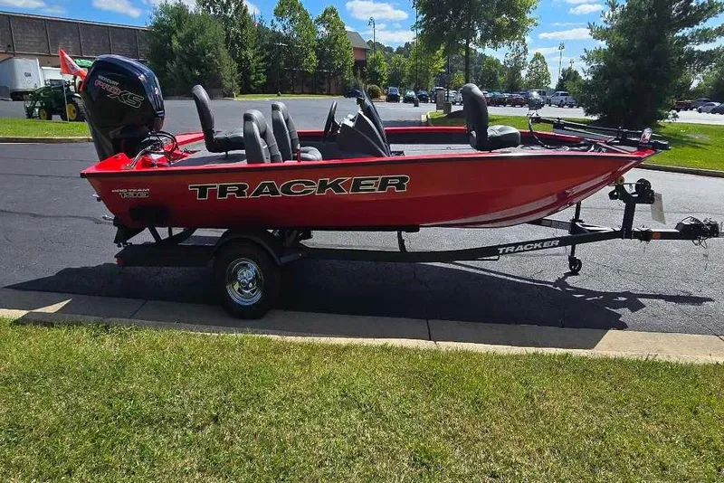 Slide: The Image of 2026 Tracker Pro Team 190 boat on trailer, parked outdoors on sunny day. - 2