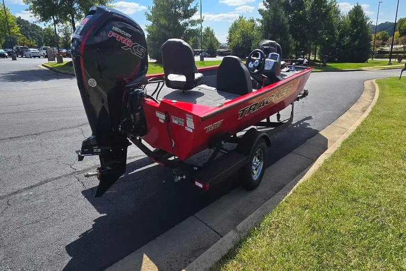 Slide: The Image of 2026 Tracker Pro Team 190 boat with Mercury engine, parked on a sunny day. - 5